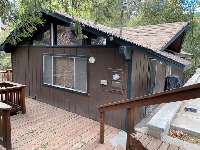 a view of backyard with wooden deck and wooden floor