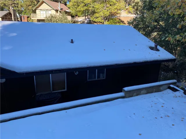 a front view of a house with yard and seating area