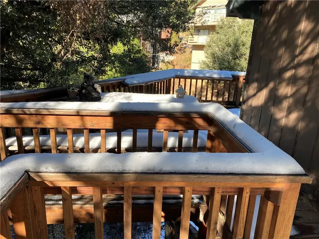 a view of balcony with wooden floor and fence