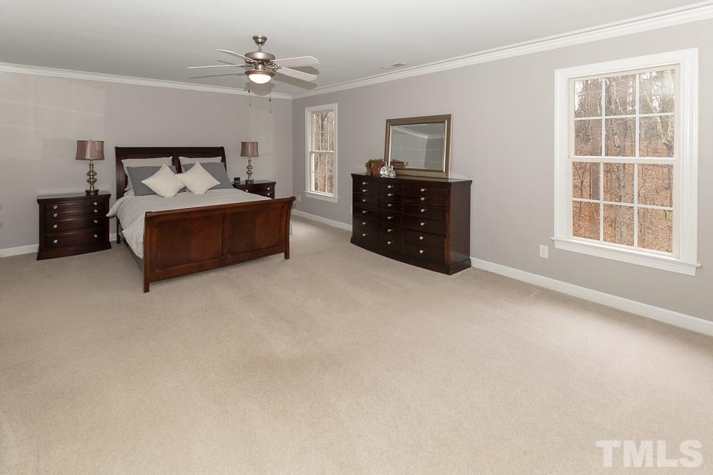 2924 Sunnystone Way Raleigh, NC 27613 - Photo 13 of 30 a living room with furniture a bed and a window