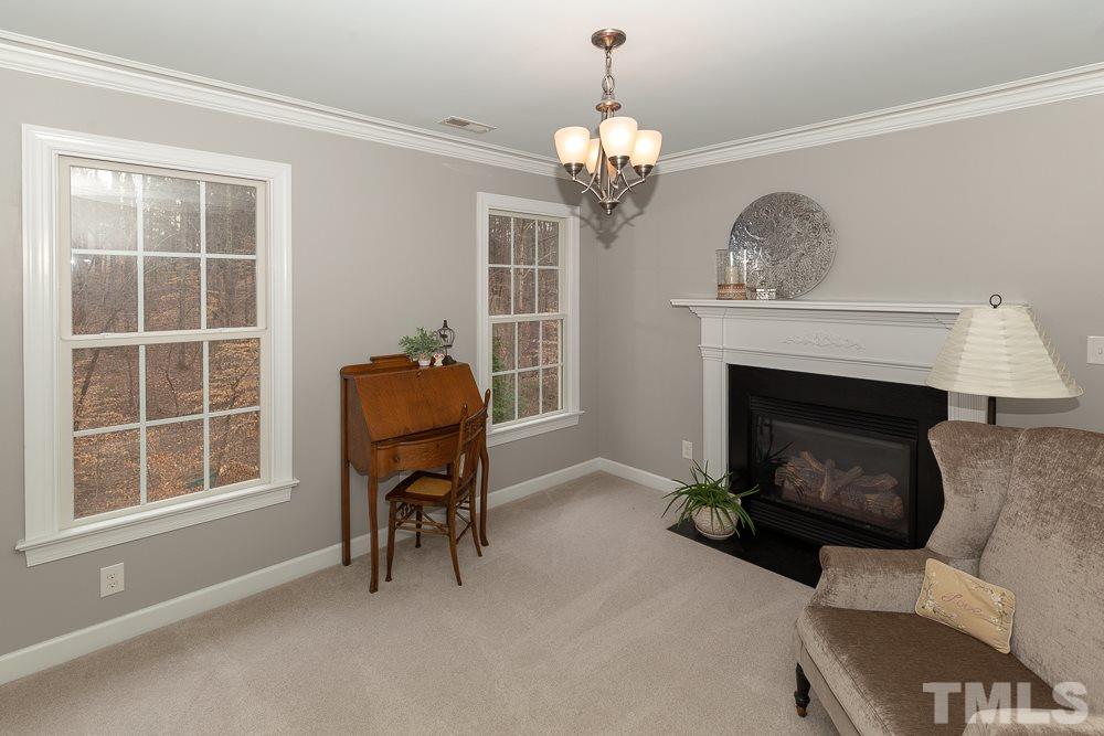2924 Sunnystone Way Raleigh, NC 27613 - Photo 14 of 30 a living room with furniture and a fireplace