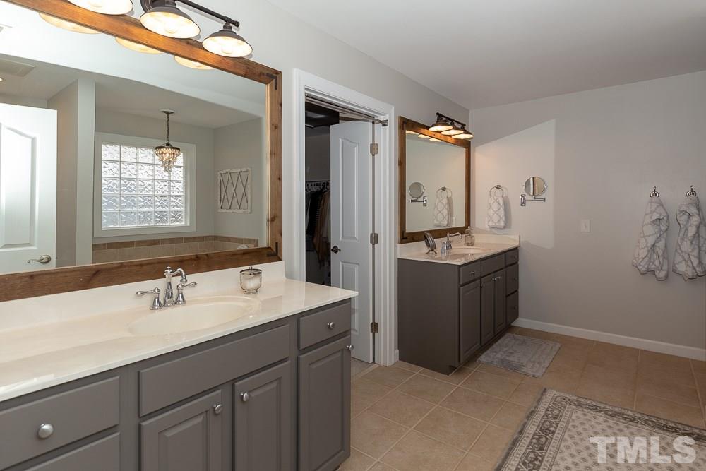 2924 Sunnystone Way Raleigh, NC 27613 - Photo 15 of 30 a bathroom with a sink double vanity and a mirror