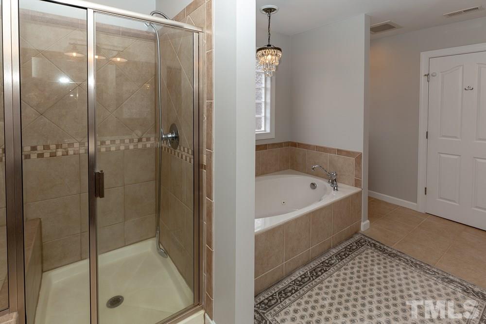 2924 Sunnystone Way Raleigh, NC 27613 - Photo 16 of 30 a bathroom with a bathtub and a shower