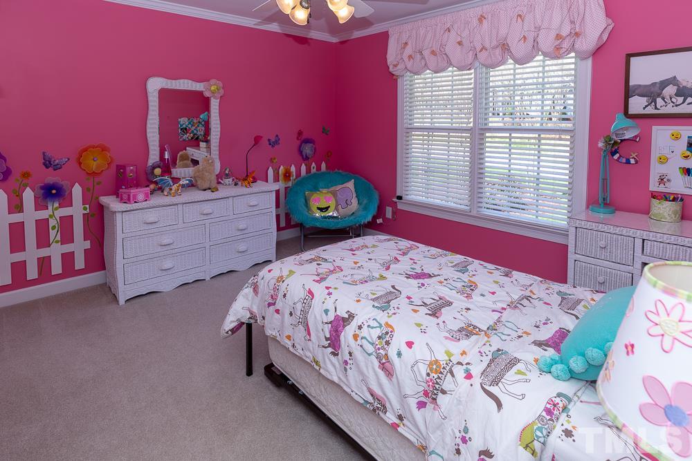 2924 Sunnystone Way Raleigh, NC 27613 - Photo 18 of 30 a bedroom with a bed and a dresser