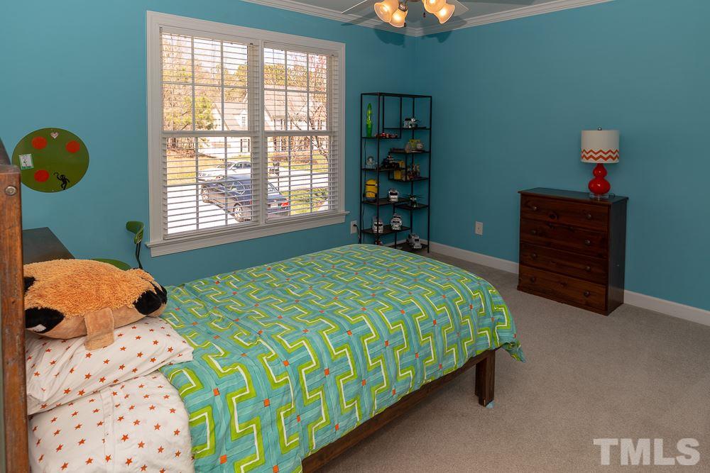 2924 Sunnystone Way Raleigh, NC 27613 - Photo 19 of 30 a bedroom with a bed and a window