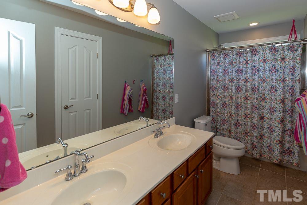 2924 Sunnystone Way Raleigh, NC 27613 - Photo 20 of 30 a bathroom with a sink and a mirror