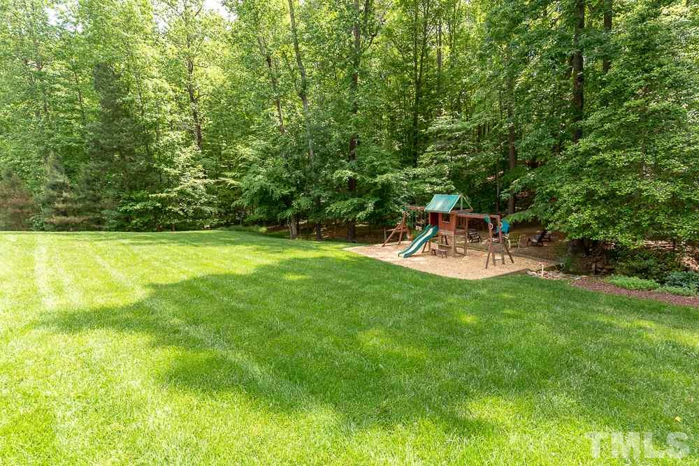 2924 Sunnystone Way Raleigh, NC 27613 - Photo 29 of 30 a view of a backyard with a garden and table