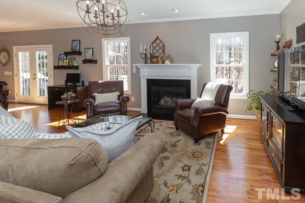 2924 Sunnystone Way Raleigh, NC 27613 - Photo 5 of 30 a living room with furniture fireplace and flat screen tv