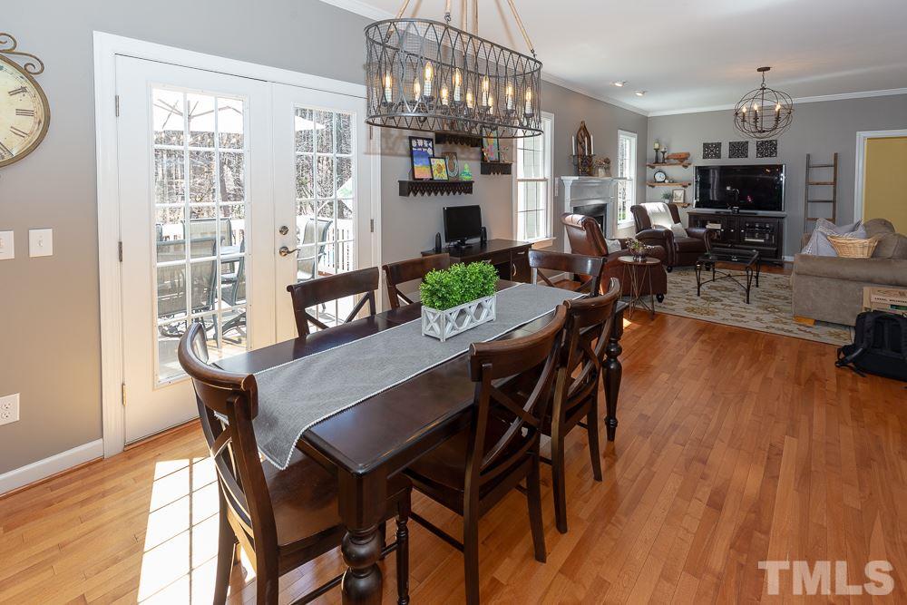 2924 Sunnystone Way Raleigh, NC 27613 - Photo 6 of 30 a view of a dining room with furniture a chandelier and wooden floor