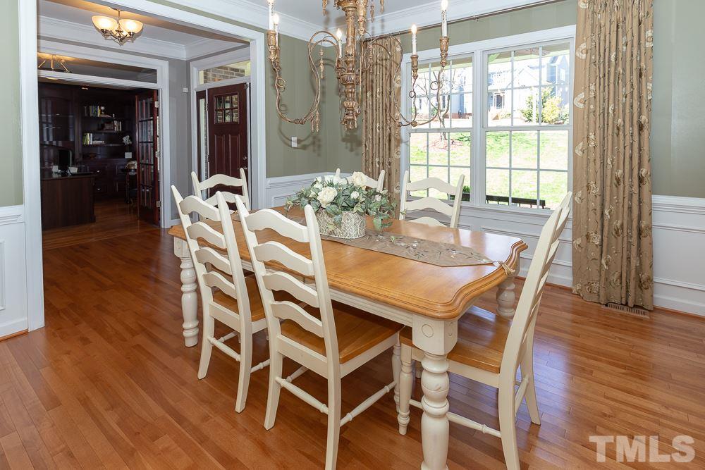 2924 Sunnystone Way Raleigh, NC 27613 - Photo 7 of 30 a dining room with furniture window wooden floor