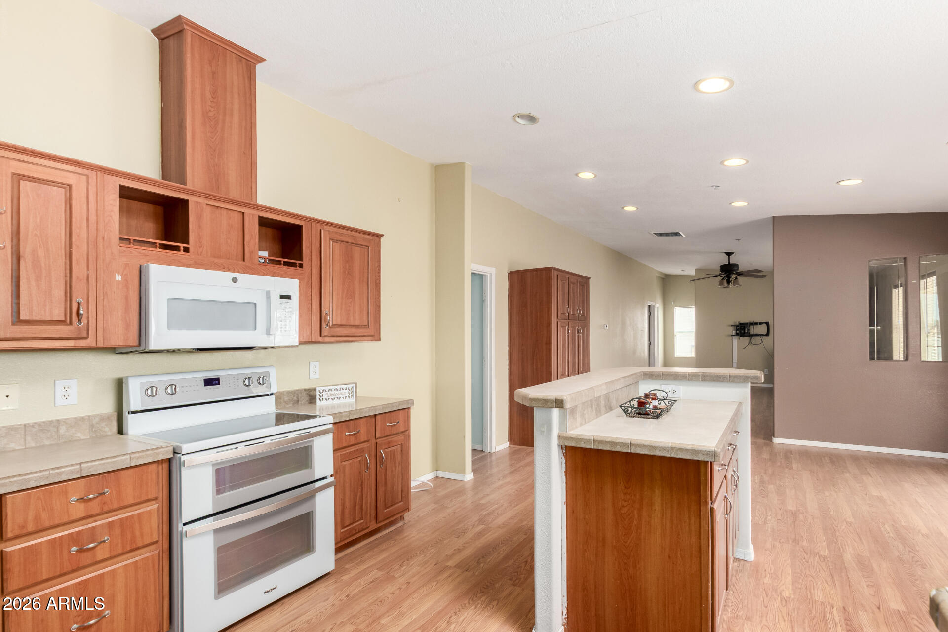 23851 West Tether Trail Wittmann, AZ 85361 - Photo 14 of 44 a kitchen with stainless steel appliances granite countertop a refrigerator a stove and a wooden floors