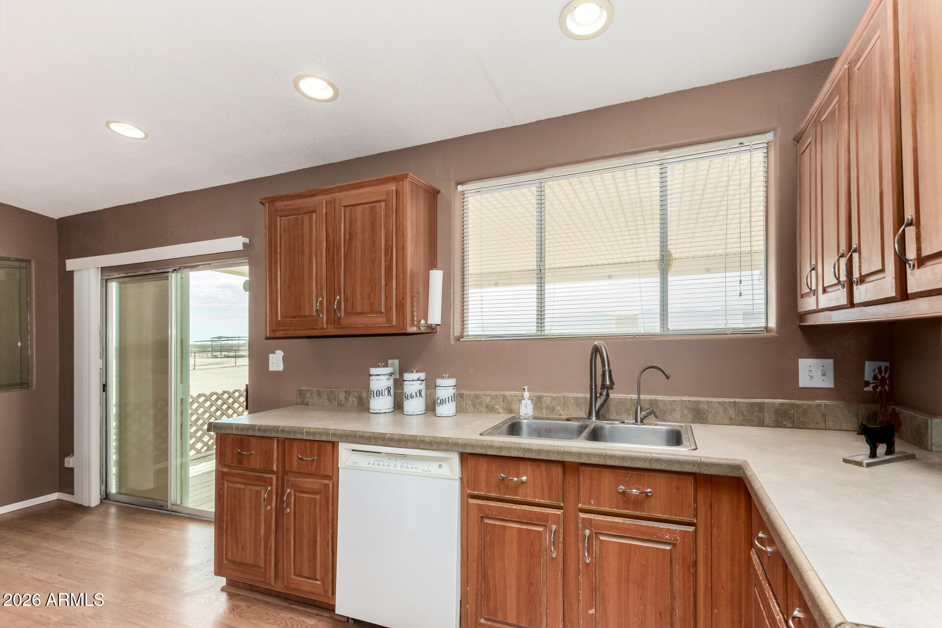 23851 West Tether Trail Wittmann, AZ 85361 - Photo 16 of 44 a kitchen with stainless steel appliances granite countertop a sink stove and cabinets