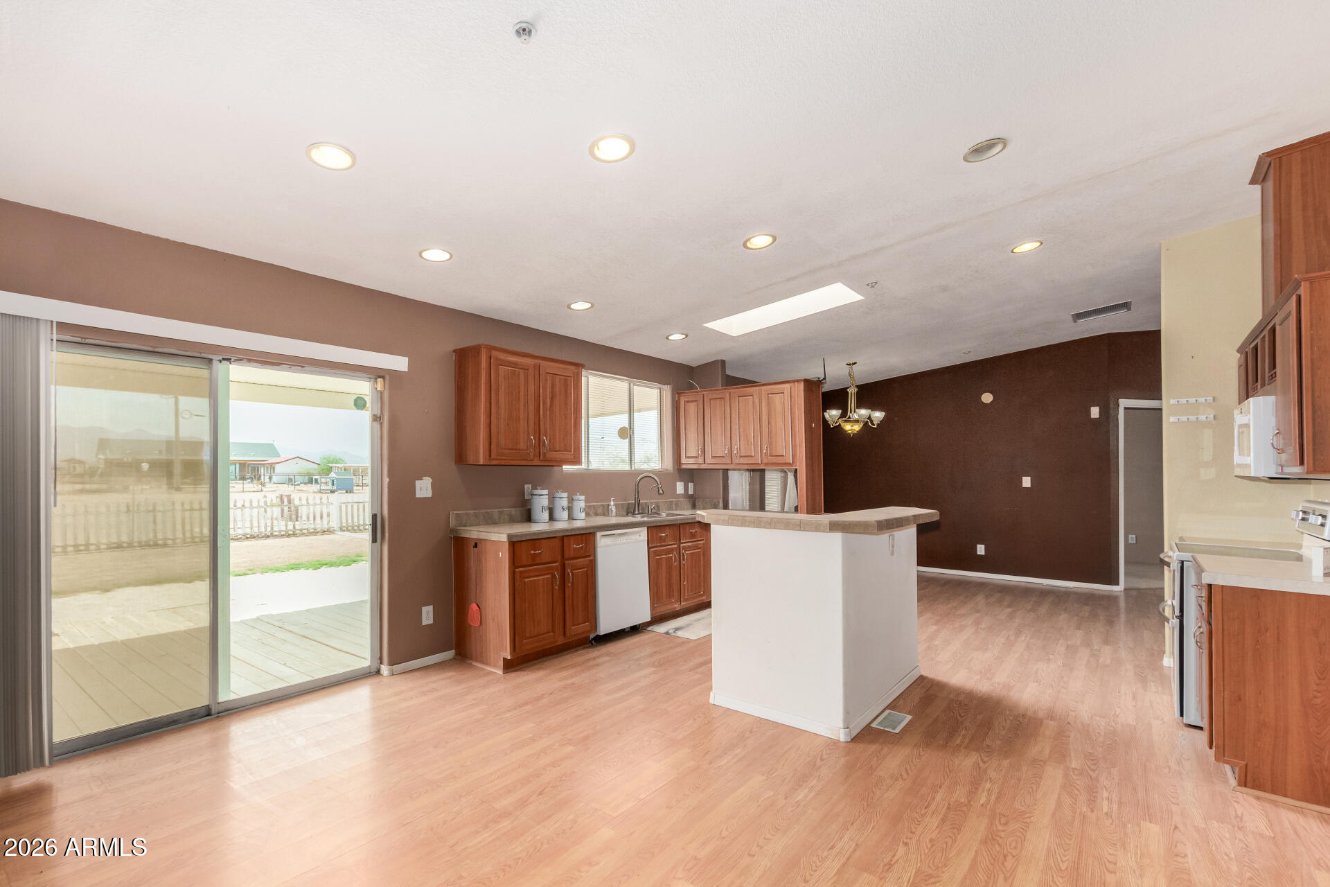 23851 West Tether Trail Wittmann, AZ 85361 - Photo 18 of 44 a kitchen with a wooden floor and window