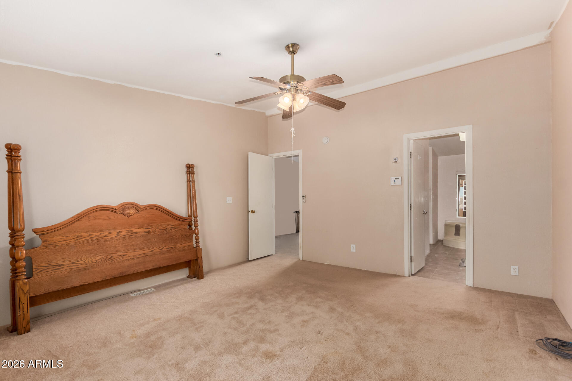 23851 West Tether Trail Wittmann, AZ 85361 - Photo 19 of 44 a view of a bedroom with closet and ceiling fan