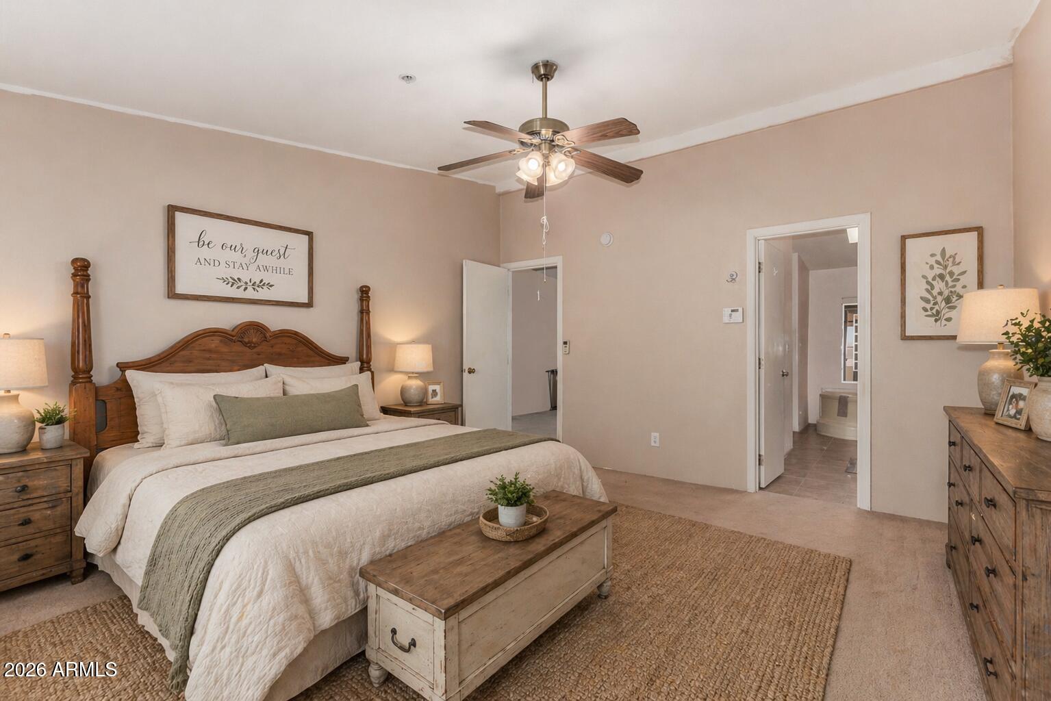 23851 West Tether Trail Wittmann, AZ 85361 - Photo 20 of 44 a bedroom with a bed and a chandelier