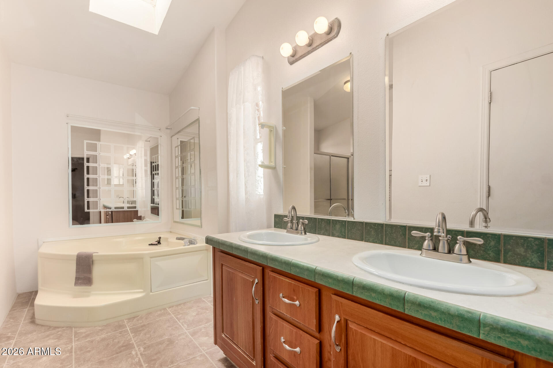 23851 West Tether Trail Wittmann, AZ 85361 - Photo 22 of 44 a bathroom with a sink double vanity mirror and a bathtub