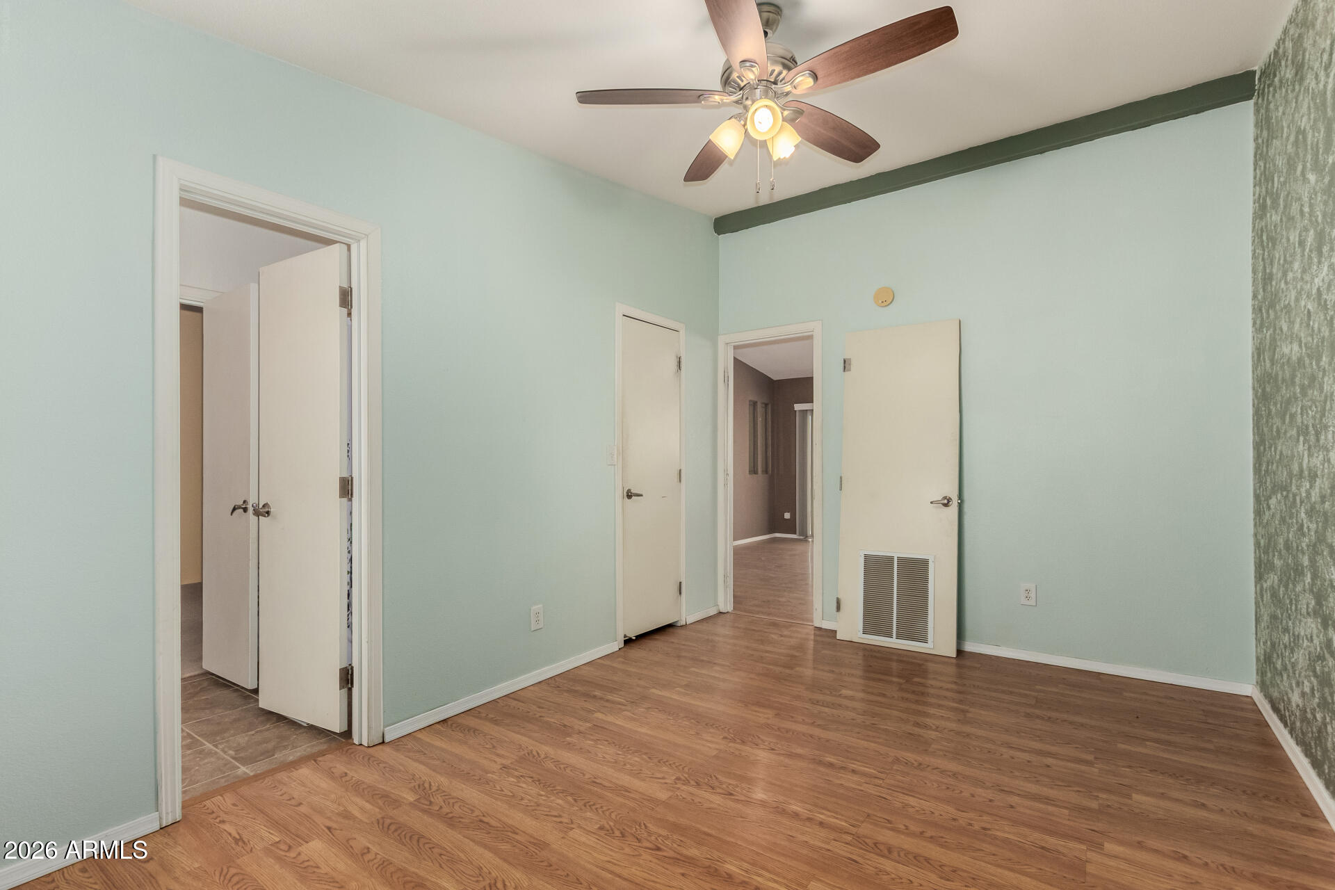 23851 West Tether Trail Wittmann, AZ 85361 - Photo 27 of 44 a view of an empty room with wooden floor