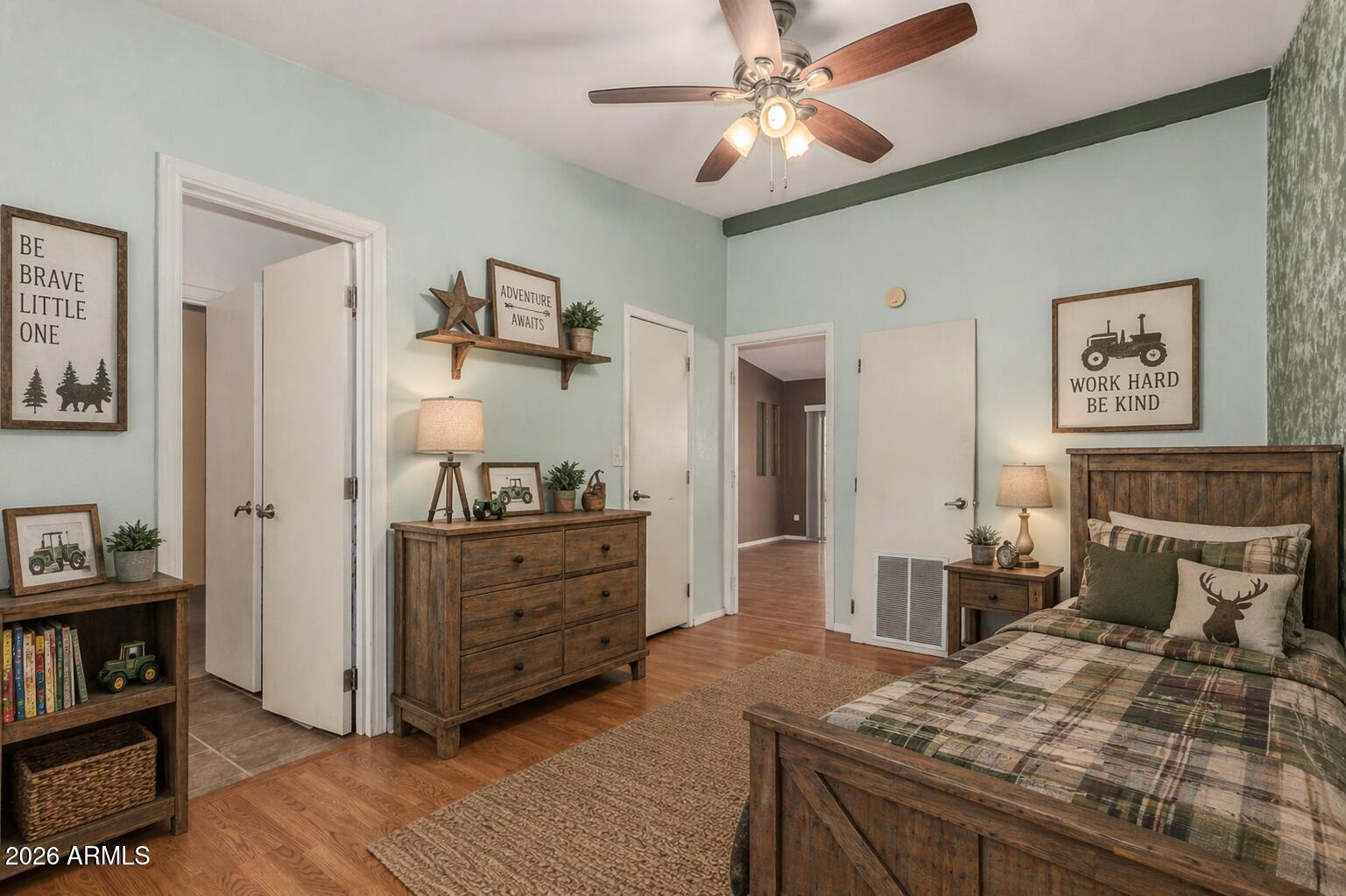 23851 West Tether Trail Wittmann, AZ 85361 - Photo 28 of 44 a bedroom with a bed and a chandelier