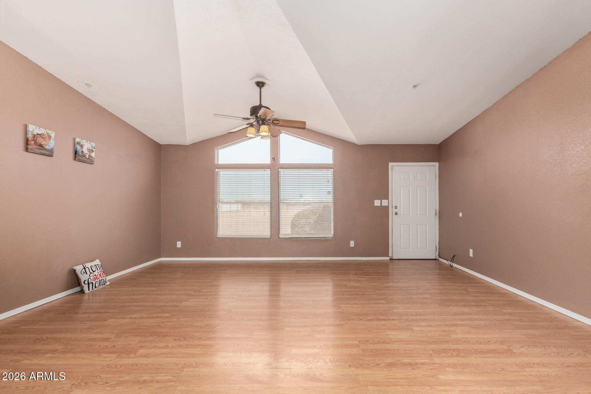 23851 West Tether Trail Wittmann, AZ 85361 - Photo 5 of 44 a view of an empty room with a window and wooden floor