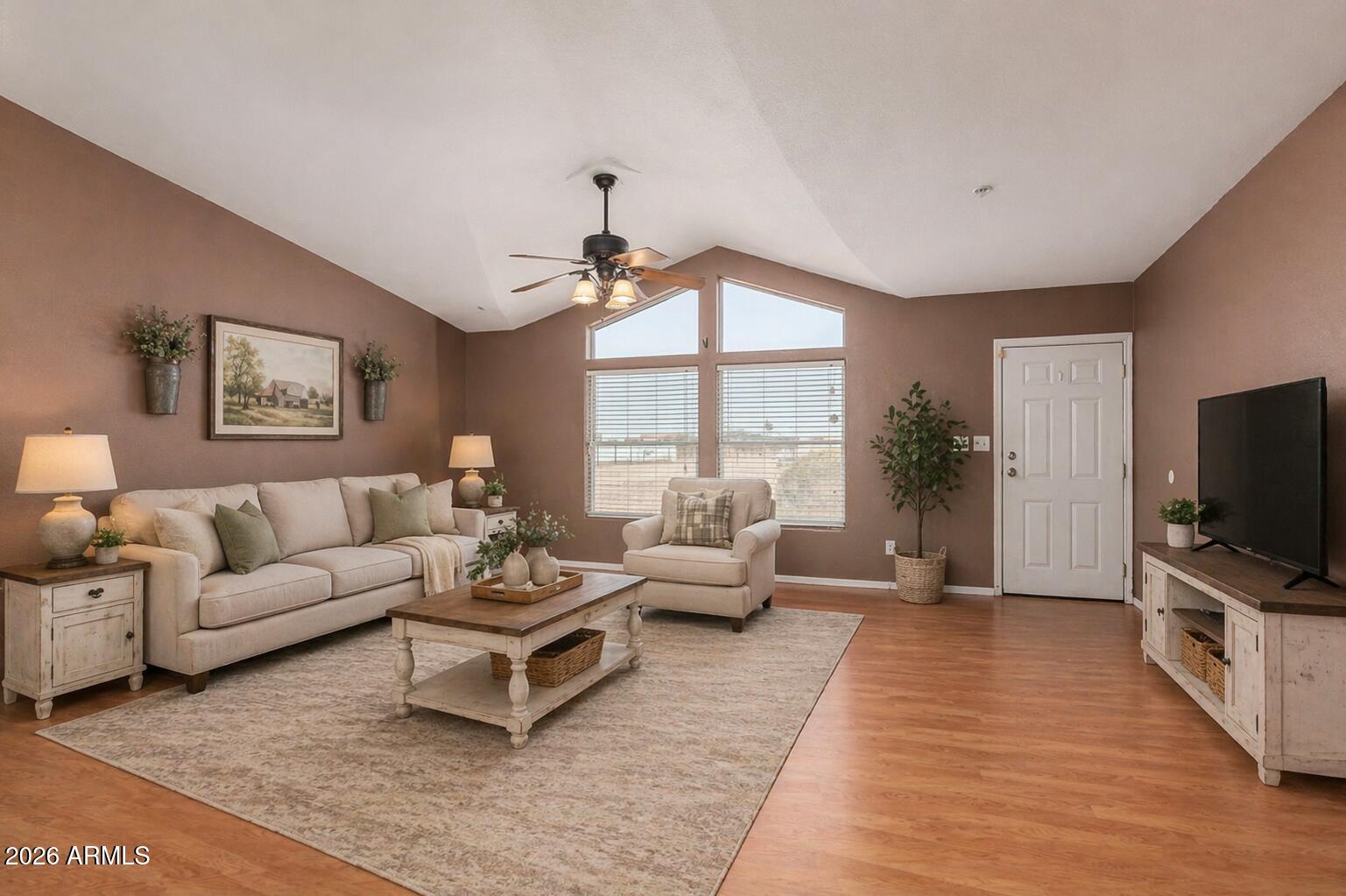 23851 West Tether Trail Wittmann, AZ 85361 - Photo 6 of 44 a living room with furniture flat screen tv and a large window