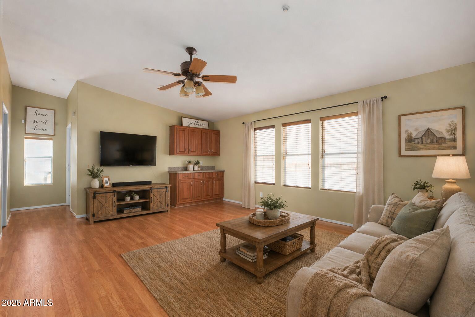 23851 West Tether Trail Wittmann, AZ 85361 - Photo 9 of 44 a living room with furniture a flat screen tv and wooden floor