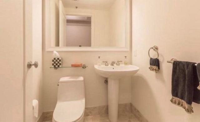 a bathroom with a sink toilet and mirror