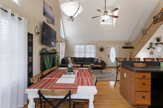 a living room with furniture a chandelier a rug and a window