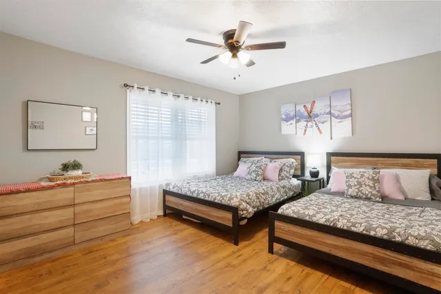 a bedroom with a bed and a chandelier