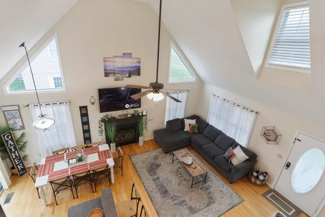a spacious bedroom with a bed and a chandelier