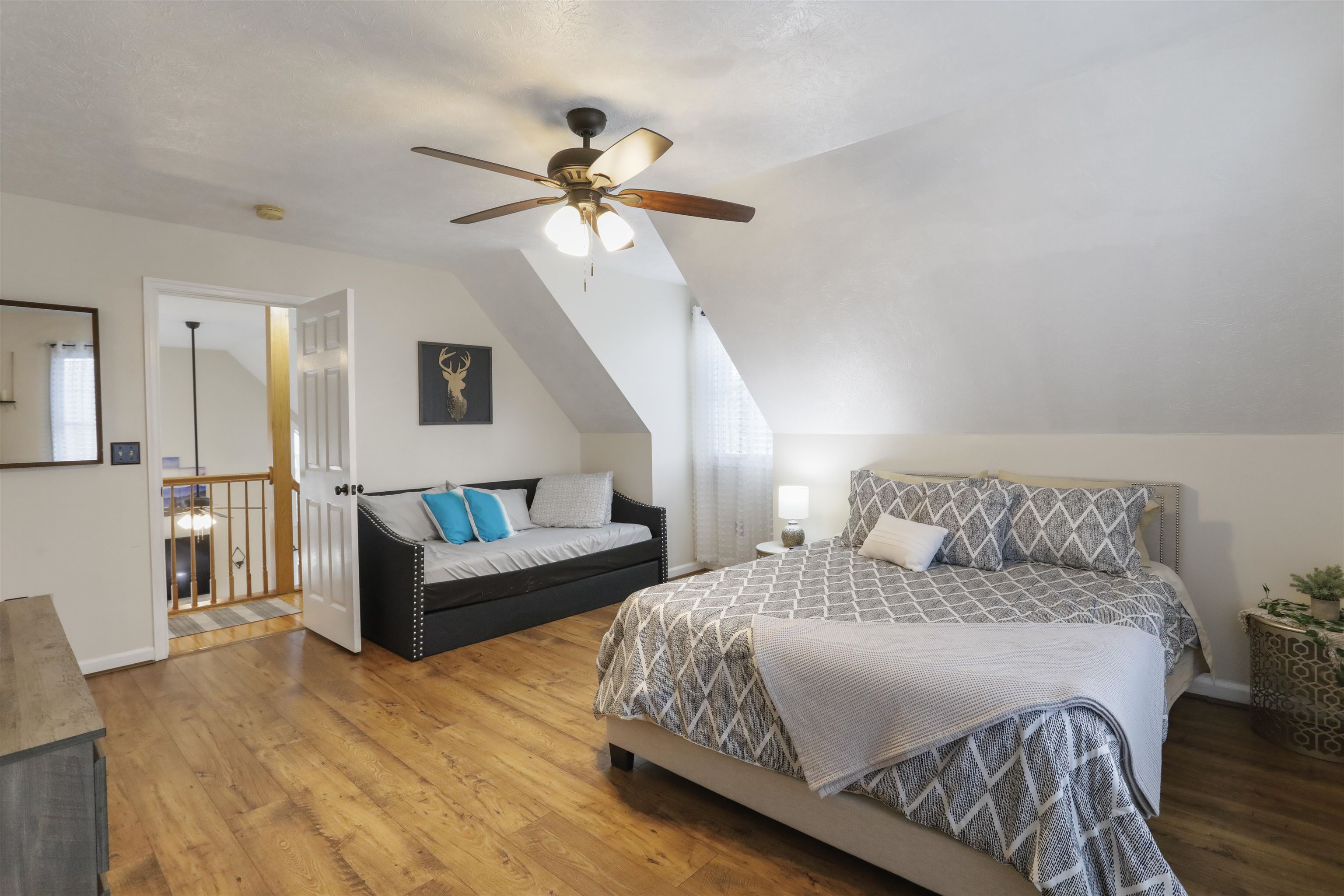 317 Locustdale Loop Shenandoah, VA 22849 - Photo 19 of 39 a spacious bedroom with a bed and a chandelier