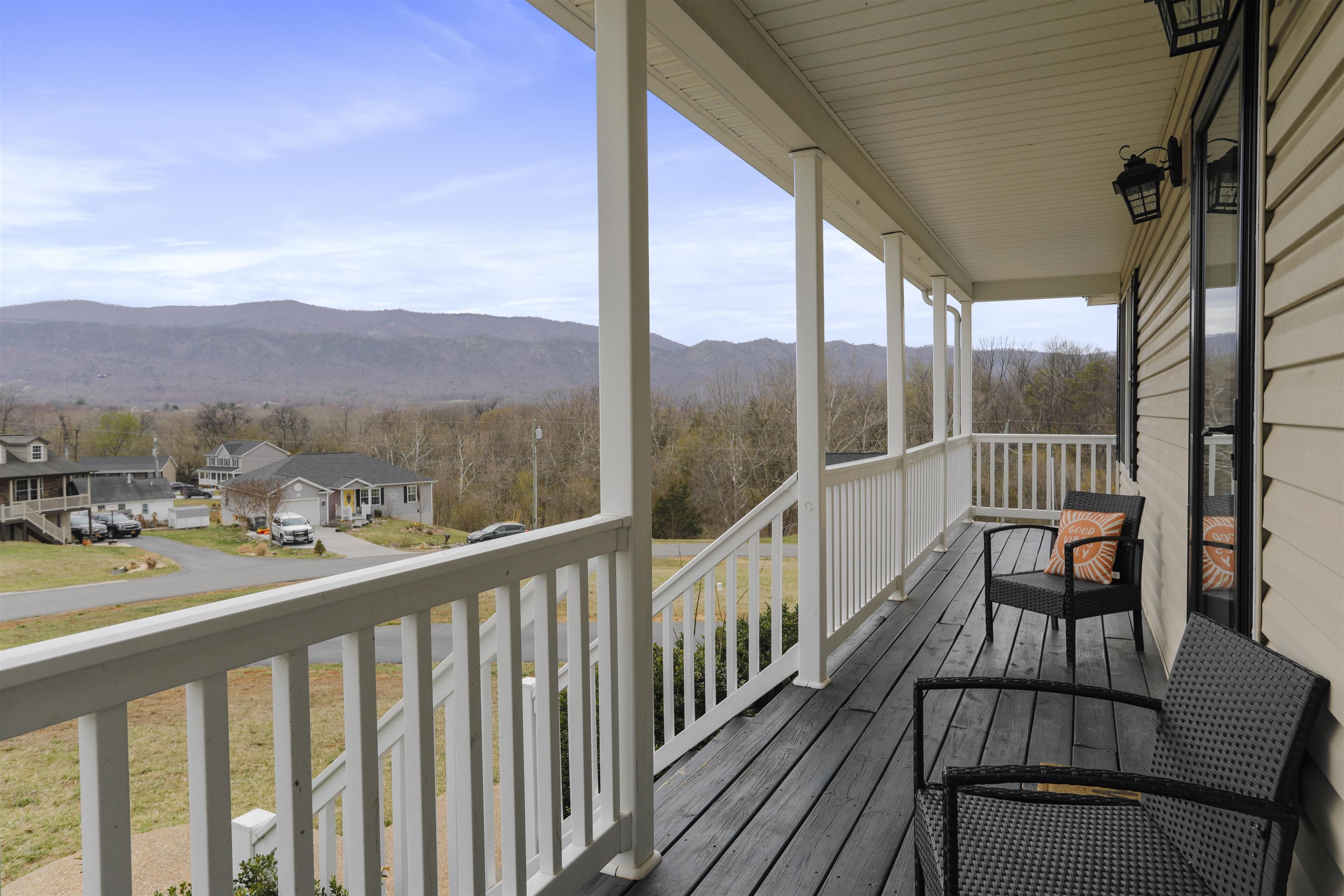 317 Locustdale Loop Shenandoah, VA 22849 - Photo 2 of 39 a view of a city from a balcony with wooden floor and a floor to ceiling window