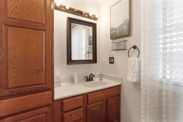 a white toilet sitting next to a shower curtain