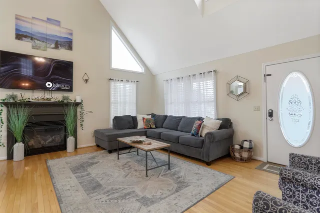 a living room with furniture a window and a fireplace