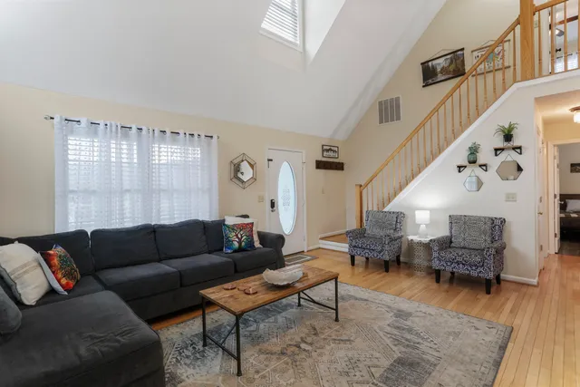 a living room with furniture and wooden floor