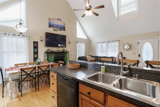 a kitchen with a table chairs sink and cabinets