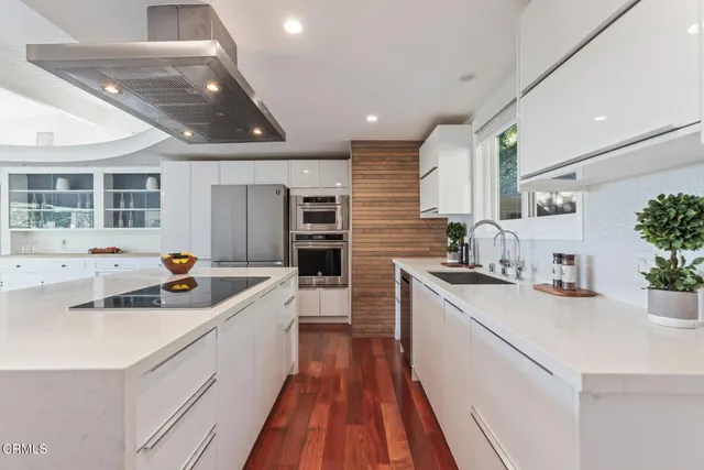 a kitchen with stainless steel appliances kitchen island granite countertop a sink and cabinets