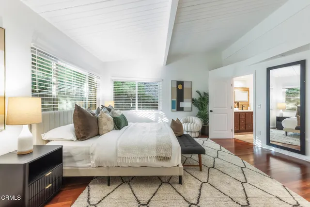 a spacious bathroom with a tub sink and mirror
