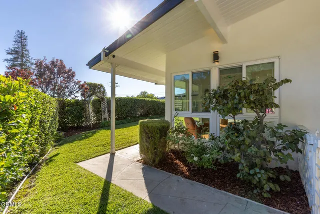 a view of a house with backyard and porch