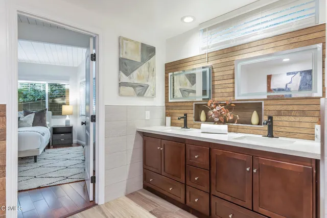 a living room with furniture a clock and a large window