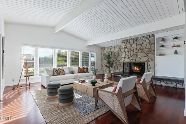 a living room with furniture a rug and a fireplace