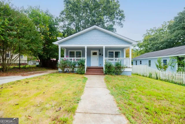 a view of house that has a yard
