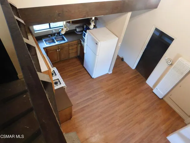 a view of washer and dryer with wooden floor