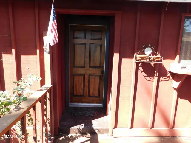 a view of a balcony with chair and the door