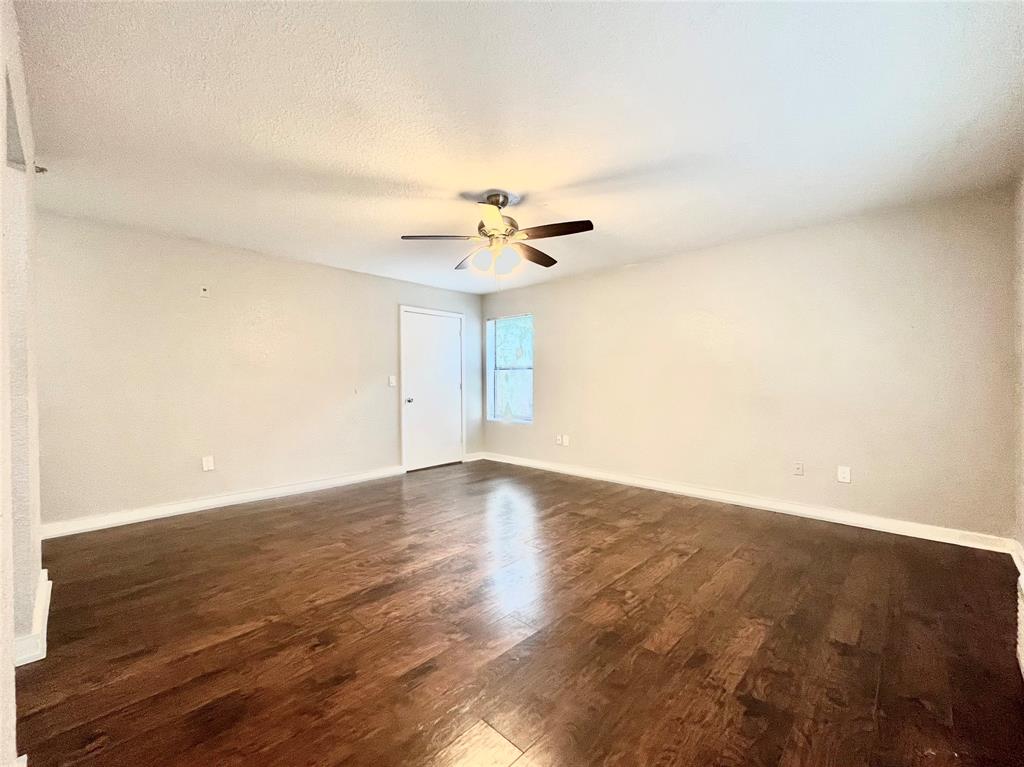 701 West Sycamore Street, Unit 107 Denton, TX 76201 - Photo 3 of 11 wooden floor in an empty room