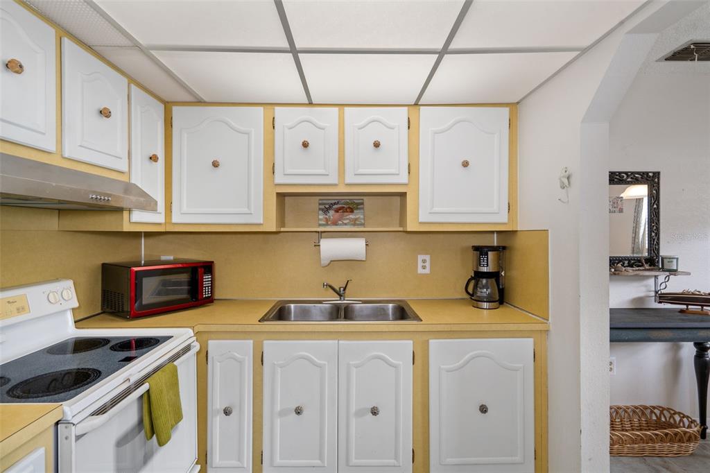 11630 Bayonet Lane New Port Richey, FL 34654 - Photo 11 of 58 a kitchen with stainless steel appliances granite countertop a sink a stove and cabinets