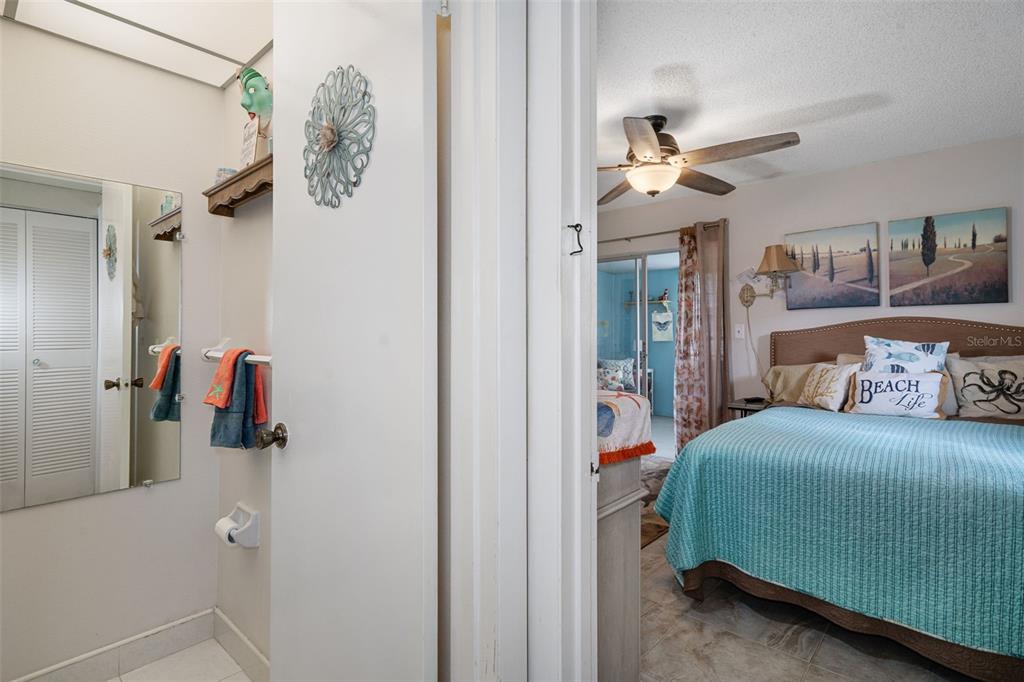 11630 Bayonet Lane New Port Richey, FL 34654 - Photo 14 of 58 a bedroom with a bed and a chandelier