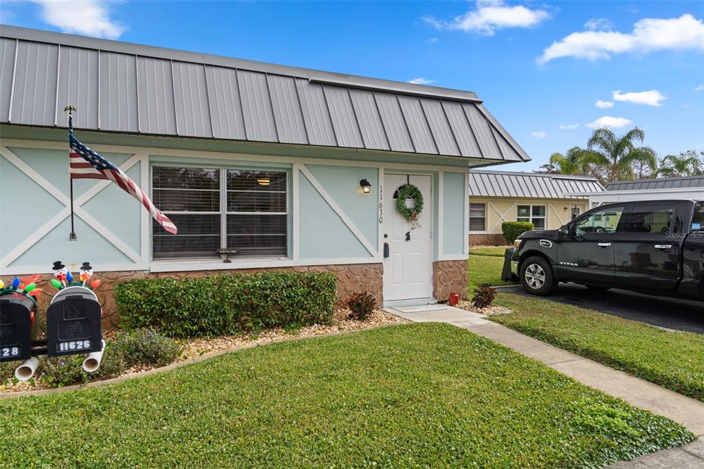 11630 Bayonet Lane New Port Richey, FL 34654 - Photo 2 of 58 a front view of a house with a garden