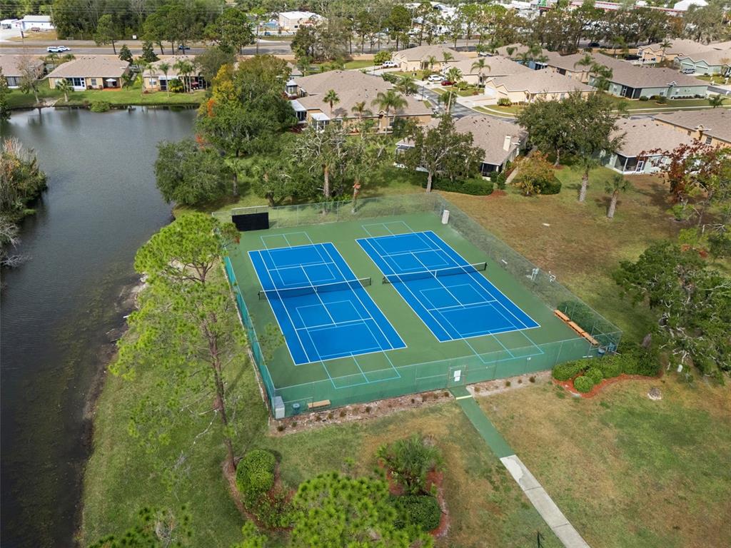 11630 Bayonet Lane New Port Richey, FL 34654 - Photo 30 of 58 an aerial view of a residential houses with outdoor space and lake view