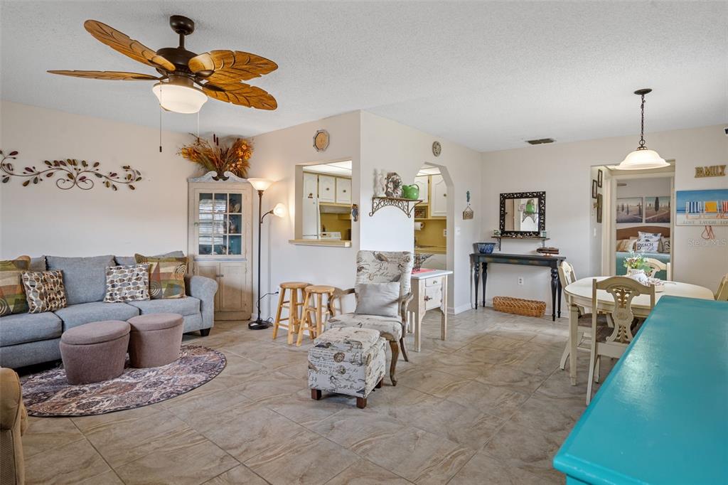 11630 Bayonet Lane New Port Richey, FL 34654 - Photo 4 of 58 a living room with furniture a chandelier fan and a window
