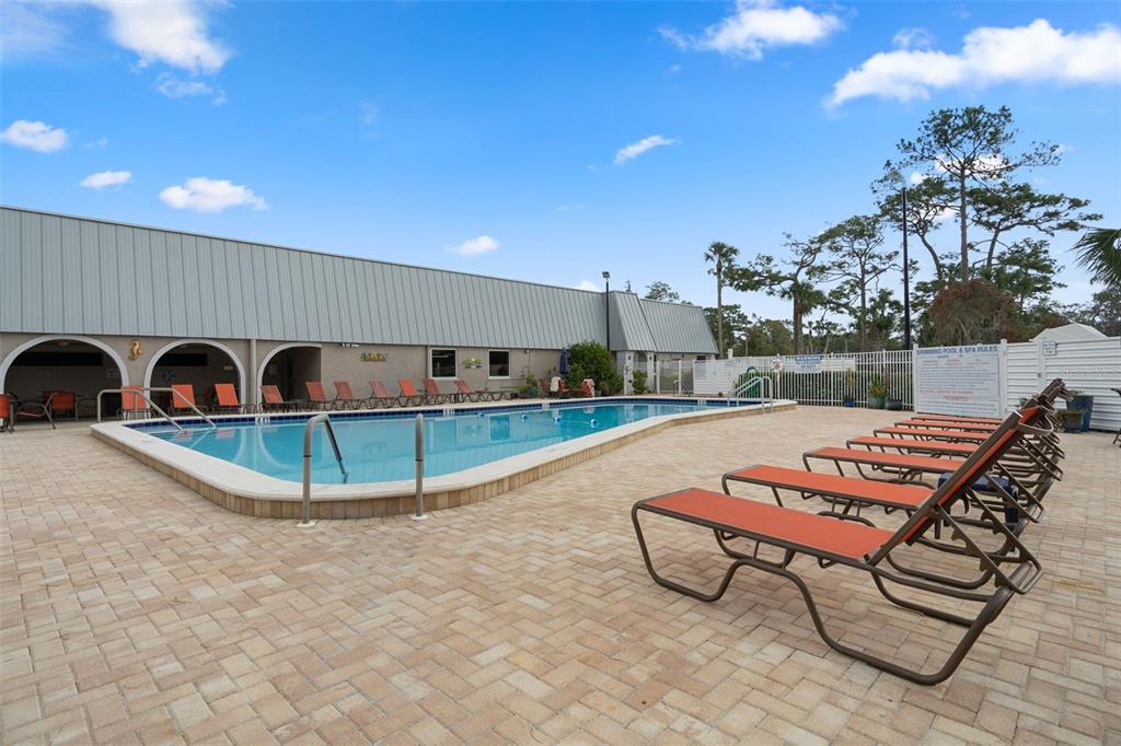 11630 Bayonet Lane New Port Richey, FL 34654 - Photo 44 of 58 a swimming pool with outdoor seating and yard